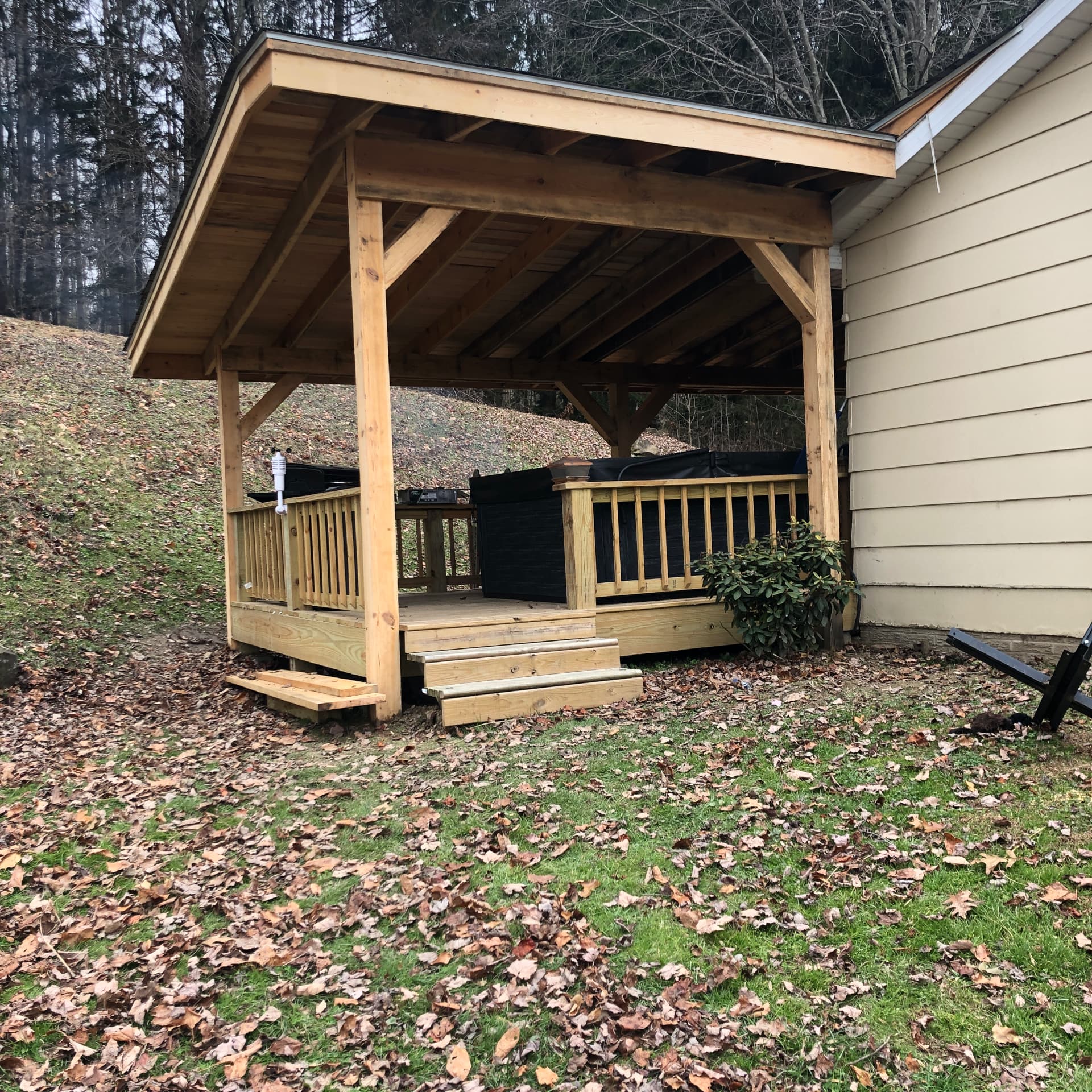 Timber-framed hot tub pavilion with deck and steps